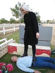 Blonde mistress tramples a slave